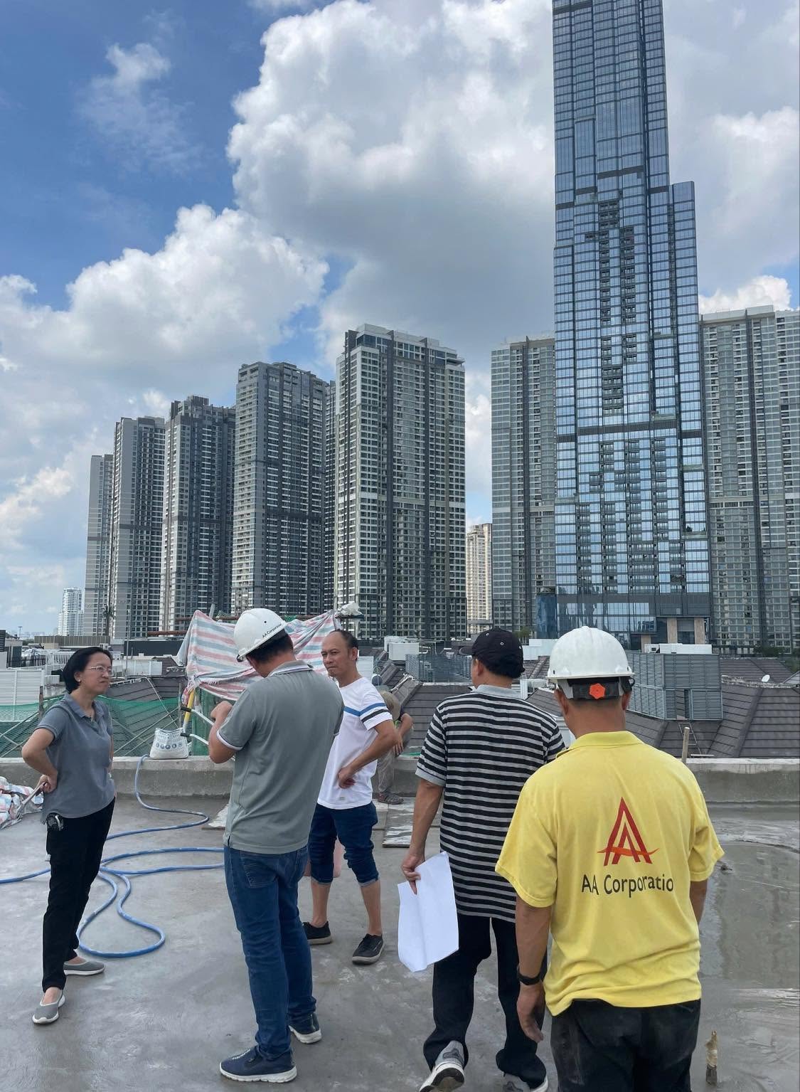 SolarTNP engineers assessing a rooftop site against the city skyline
