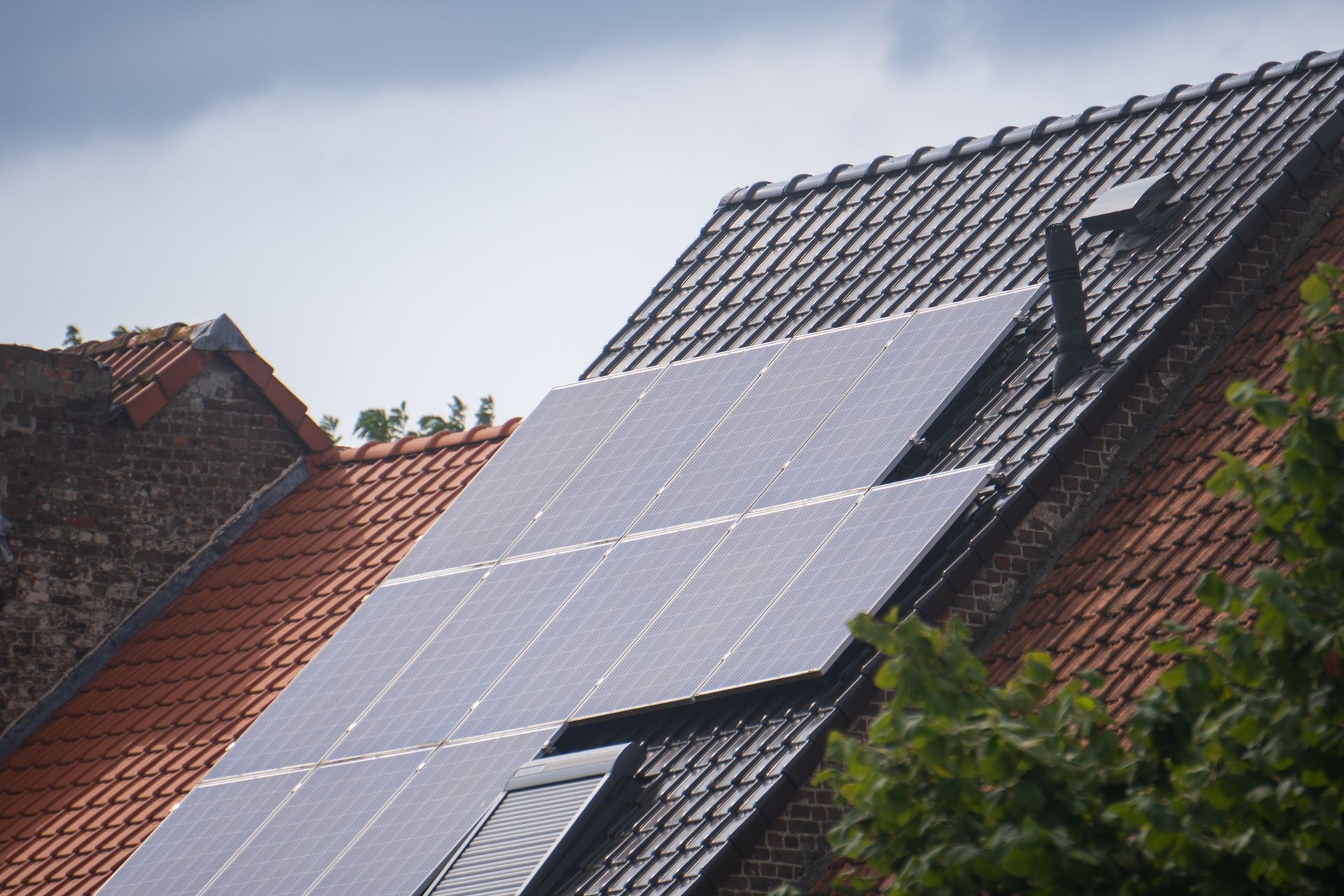 Solar panels precisely mounted on a tile roof, aligned and flush with the roofline